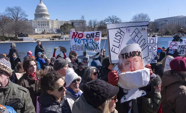 People protest as part of the "No Kings Day" protest on Presidents Day in Washington, against President Donald Trump and Elon Musk, Monday, Feb. 17, 2025, by the Capitol in Washington. The protest was organized by the 50501 Movement, which stands for 50 Protests 50 States 1 Movement. (AP Photo/Jacquelyn Martin)