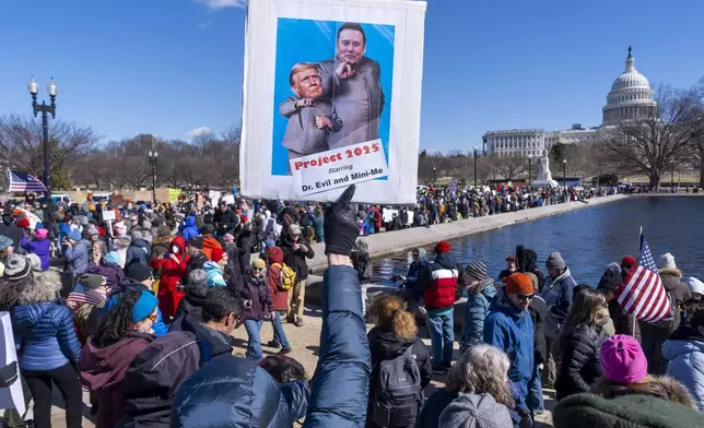 People protest as part of the “No Kings Day” protest on Presidents Day in Washington, in support of federal workers and against recent actions by President Donald Trump and Elon Musk, Monday, Feb. 17, 2025, by the Capitol in Washington. (AP Photo/Jacquelyn Martin)
