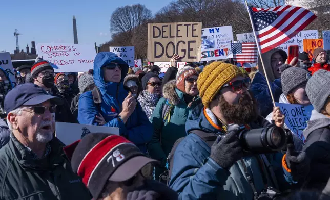 People protest as part of the “No Kings Day” protest on Presidents Day in Washington, in support of federal workers and against recent actions by President Donald Trump and Elon Musk, Monday, Feb. 17, 2025, by the Capitol in Washington. (AP Photo/Jacquelyn Martin)