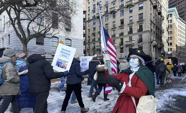 Demonstrators join more than a thousand people protesting the policies of the Trump administration marched from the Boston Common past City Hall to the North End, Monday, Feb. 17, 2025 in Boston. (AP/Michael Casey)