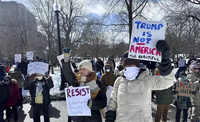 Demonstrators join more than a thousand people protesting the policies of the Trump administration marched from the Boston Common past City Hall to the North End, Monday, Feb. 17, 2025 in Boston. (AP/Michael Casey)