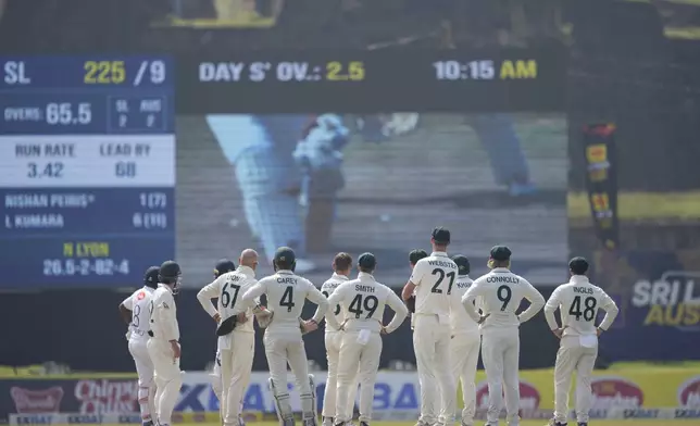 Australia's team members await a decision review during day four of the second test cricket match between Sri Lanka and Australia in Galle, Sri Lanka, Sunday, Feb. 9, 2025. (AP Photo/Eranga Jayawardena)