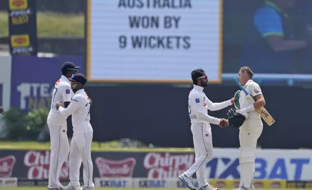 Sri Lanka's captain Dhananjaya de Silva congratulates Australia's Marnus Labuschagne for their win during day four of the second test cricket match between Sri Lanka and Australia in Galle, Sri Lanka, Sunday, Feb. 9, 2025. (AP Photo/Eranga Jayawardena)