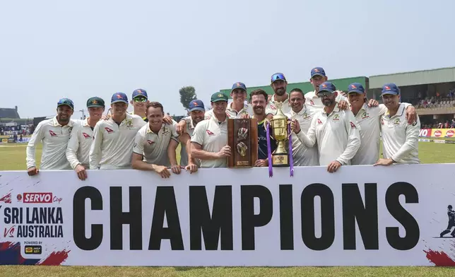 Australia's team members pose with the Warn-Muralitharan trophy at the end of second test cricket match between Sri Lanka and Australia in Galle, Sri Lanka, Sunday, Feb. 9, 2025. (AP Photo/Eranga Jayawardena)