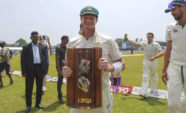 Australia's captain Steven Smith poses with the Warn-Muralitharan trophy at the end of second test cricket match between Sri Lanka and Australia in Galle, Sri Lanka, Sunday, Feb. 9, 2025. (AP Photo/Eranga Jayawardena)