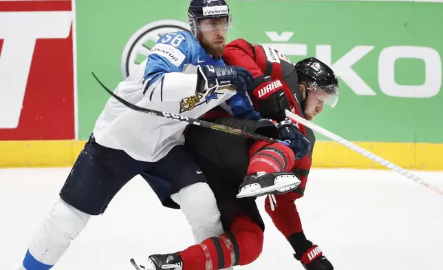 FILE - Finland's Jani Hakanpaa (58) checks Canada's Anthony Mantha, right, during the Ice Hockey World Championships gold medal match at the Ondrej Nepela Arena in Bratislava, Slovakia, Sunday, May 26, 2019. (AP Photo/Petr David Josek, File)