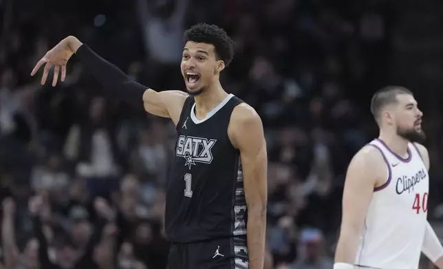 San Antonio Spurs center Victor Wembanyama (1) reacts to a score against the LA Clippers during the second half of an NBA basketball game in San Antonio, Wednesday, Jan. 29, 2025. (AP Photo/Eric Gay)