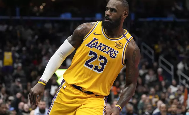 Los Angeles Lakers forward LeBron James reacts after dunking against the Washington Wizards during the second half of an NBA basketball game Thursday, Jan. 30, 2025, in Washington. (AP Photo/Jess Rapfogel)