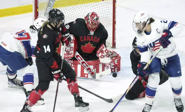 Team Canada goaltender Emerance Maschmeyer, center, makes a save during the first period of Rivalry Series hockey game against Team USA in Summerside, Prince Edward Island, Canada, Saturday, Feb. 8, 2025. (Darren Calabrese/The Canadian Press via AP)