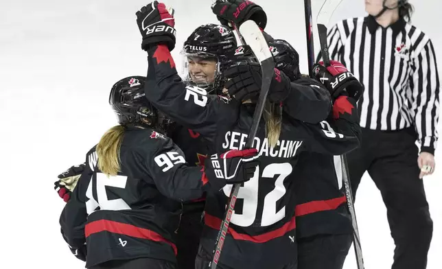 Members of Team Canada celebrate a goal against the United States during the second period of a Rivalry Series hockey game in Summerside, Prince Edward Island, Canada, Saturday, Feb. 8, 2025. (Darren Calabrese/The Canadian Press via AP)