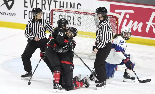 Canada's Laura Stacey (7) celebrates after her empty-net goal with teammate Kristin O'Neill (43) near United States' Kelly Pannek (12) during the third period of a Rivalry Series hockey game in Summerside, Prince Edward Island, Canada, Saturday, Feb. 8, 2025. (Darren Calabrese/The Canadian Press via AP)