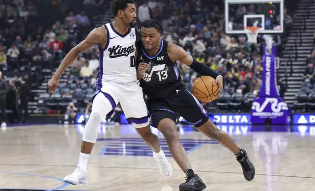 Utah Jazz guard Isaiah Collier (13) drives on Sacramento Kings guard Malik Monk (0) during the second half of an NBA basketball game, Wednesday, Feb. 26, 2025, in Salt Lake City. (AP Photo/Rob Gray)