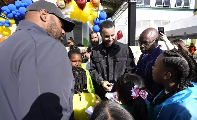 Stephen Curry visits with students of East Oakland Pride Elementary School as part of the NBA basketball league's Day of Service, Friday, Feb. 14, 2025, Oakland, Calif. (AP Photo/Godofredo A. Vásquez)