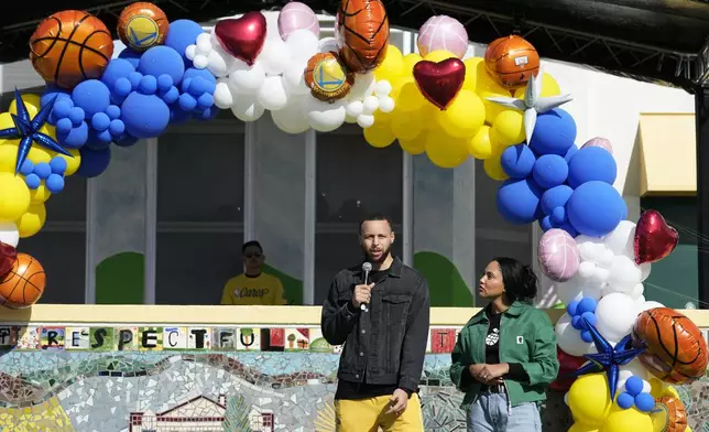 Stephen Curry and his wife Ayesha speak to students of East Oakland Pride Elementary School as part of the NBA basketball league's Day of Service, Friday, Feb. 14, 2025, Oakland, Calif. (AP Photo/Godofredo A. Vásquez)