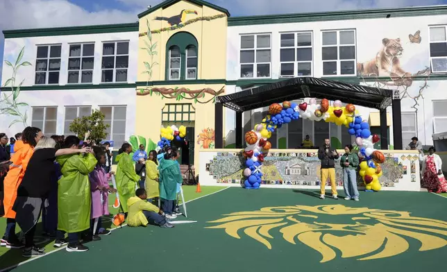 Stephen Curry and his wife Ayesha speak to students of East Oakland Pride Elementary School as part of the NBA basketball league's Day of Service, Friday, Feb. 14, 2025, Oakland, Calif. (AP Photo/Godofredo A. Vásquez)