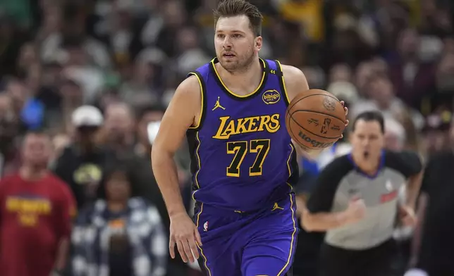 Los Angeles Lakers guard Luka Doncic brings the ball up the court against the Denver Nuggets in the first half of an NBA basketball game Saturday, Feb. 22, 2025, in Denver. (AP Photo/David Zalubowski)