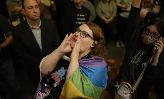 Protesters fill the Iowa state Capitol to denounce a bill that would strip the state civil rights code of protections based on gender identity, Thursday, Feb. 27, 2025, in Des Moines, Iowa. (AP Photo/Charlie Neibergall)