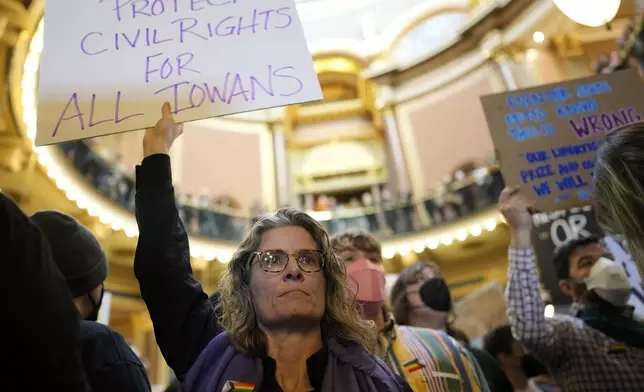 Megan Brown and other protesters fill the Iowa state Capitol to denounce a bill that would strip the state civil rights code of protections based on gender identity, Thursday, Feb. 27, 2025, in Des Moines, Iowa. (AP Photo/Charlie Neibergall)