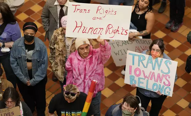 Protesters fill the Iowa state Capitol to denounce a bill that would strip the state civil rights code of protections based on gender identity, Thursday, Feb. 27, 2025, in Des Moines, Iowa. (AP Photo/Charlie Neibergall)
