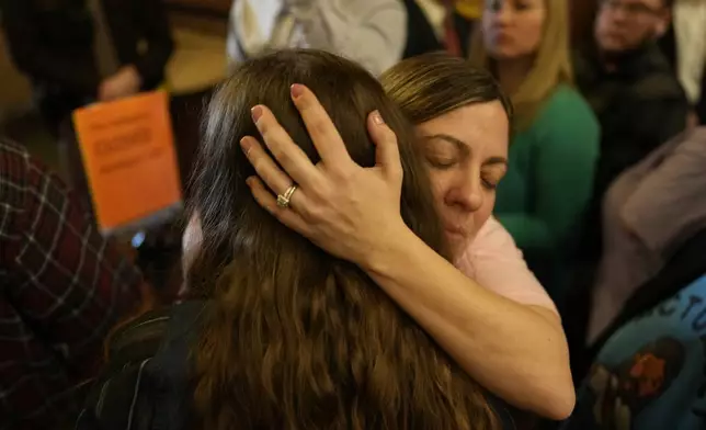Protesters fill the Iowa state Capitol to denounce a bill that would strip the state civil rights code of protections based on gender identity, Thursday, Feb. 27, 2025, in Des Moines, Iowa. (AP Photo/Charlie Neibergall)
