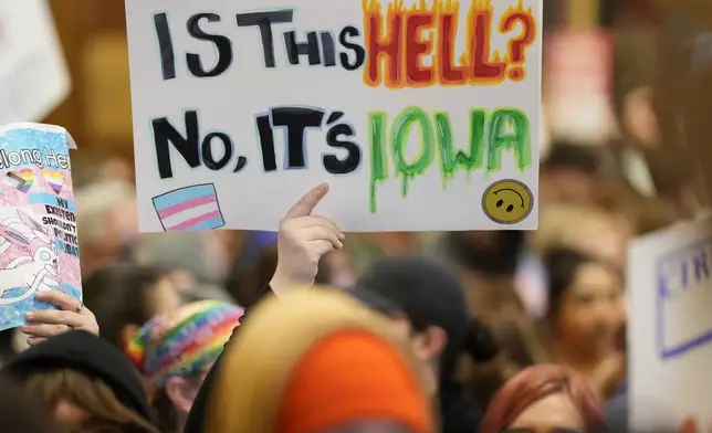 Protesters fill the Iowa state Capitol to denounce a bill that would strip the state civil rights code of protections based on gender identity, Thursday, Feb. 27, 2025, in Des Moines, Iowa. (AP Photo/Charlie Neibergall)