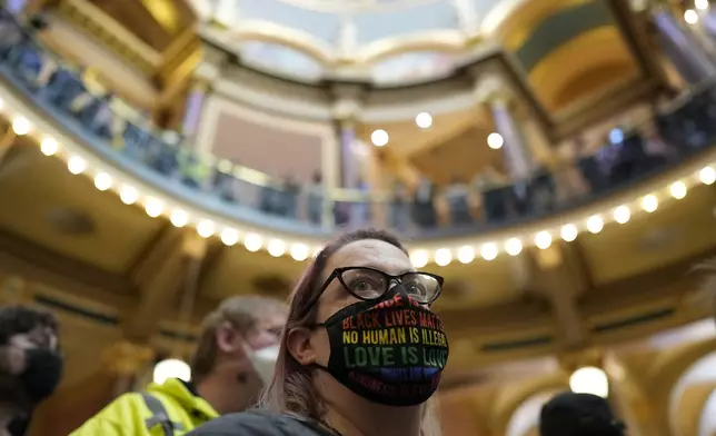 Protesters fill the Iowa state Capitol to denounce a bill that would strip the state civil rights code of protections based on gender identity, Thursday, Feb. 27, 2025, in Des Moines, Iowa. (AP Photo/Charlie Neibergall)