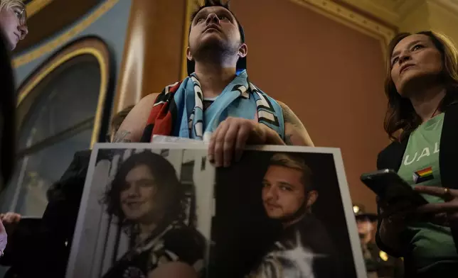 Laker Fuller and other protesters fill the Iowa state Capitol to denounce a bill that would strip the state civil rights code of protections based on gender identity, Thursday, Feb. 27, 2025, in Des Moines, Iowa. (AP Photo/Charlie Neibergall)
