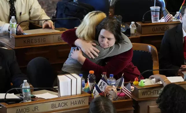 Rep. Aime Wichtendahl, D-Hiawatha, gets a hug after speaking during debate on the gender identity bill, Thursday, Feb. 27, 2025, at the Statehouse in Des Moines, Iowa. (AP Photo/Charlie Neibergall)