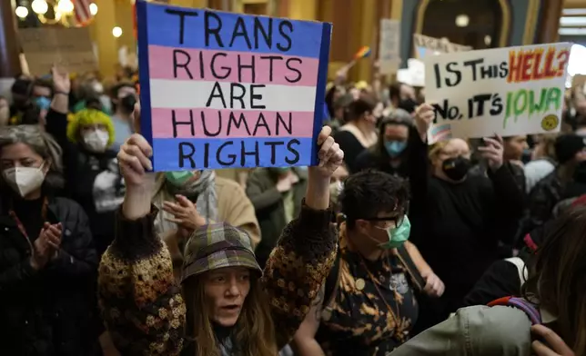Protesters fill the Iowa state Capitol to denounce a bill that would strip the state civil rights code of protections based on gender identity, Thursday, Feb. 27, 2025, in Des Moines, Iowa. (AP Photo/Charlie Neibergall)