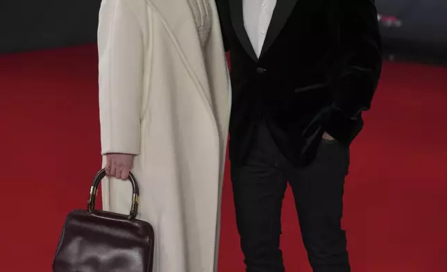 Red Bull team principal Christian Horner and his wife Geri Halliwell pose for cameras as they arrive to the F1@75 launch event at the O2 arena in London, Tuesday, Feb. 18, 2025. (AP Photo/Kin Cheung)