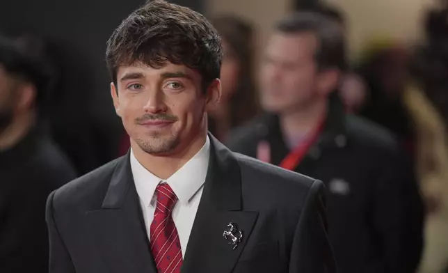 Ferrari driver Charles Leclerc of Monaco poses for cameras as he arrives to the F1 75 Live event at the O2 arena in London, Tuesday, Feb. 18, 2025. (AP Photo/Kin Cheung)