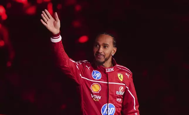 Ferrari driver Lewis Hamilton waves during the F1 75 Live event at the O2 arena in London, England, Tuesday, Feb. 18, 2025. (Bradley Collyer/PA via AP)