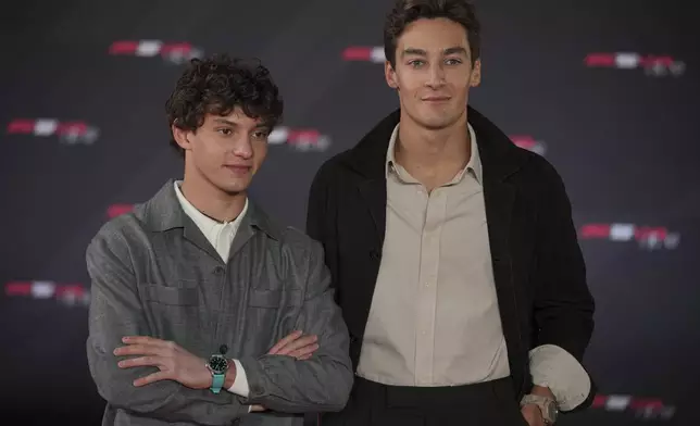 Mercedes driver Andrea Kimi Antonelli of Italy, left, and Mercedes driver George Russell of Britain pose for cameras as they arrive to the F1@75 launch event at the O2 arena in London, Tuesday, Feb. 18, 2025. (AP Photo/Kin Cheung)