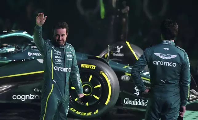 Aston Martin drivers Fernando Alonso, l,eft, and Lance Stroll, right, during the F1 75 Live event at the O2 arena in London, England, Tuesday, Feb. 18, 2025.(Bradley Collyer/PA via AP)