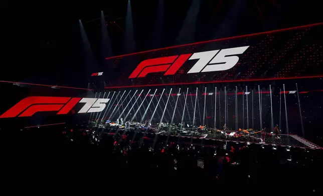 Drivers stand with their new cars during the F1 75 Live event at the O2 arena in London, Tuesday, Feb. 18, 2025.(Bradley Collyer/PA via AP)