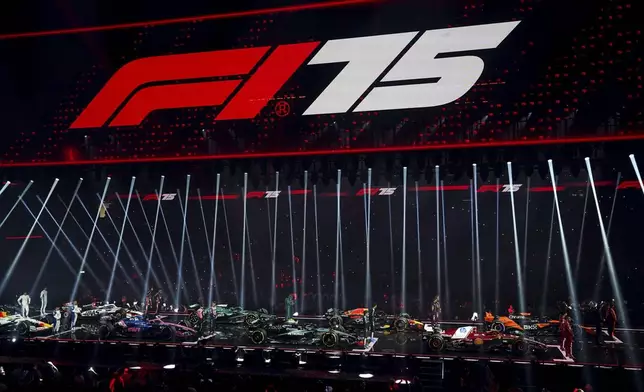 Drivers stand with their new cars during the F1 75 Live event at the O2 arena in London, Tuesday, Feb. 18, 2025.(Bradley Collyer/PA via AP)