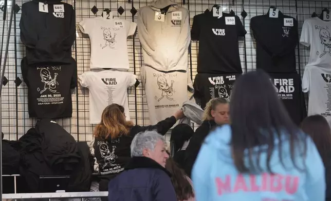 T-shirts promoting the FireAid benefit concert are seen on display on Thursday, Jan. 30, 2025, at The Forum in Inglewood, Calif. (AP Photo/Chris Pizzello)