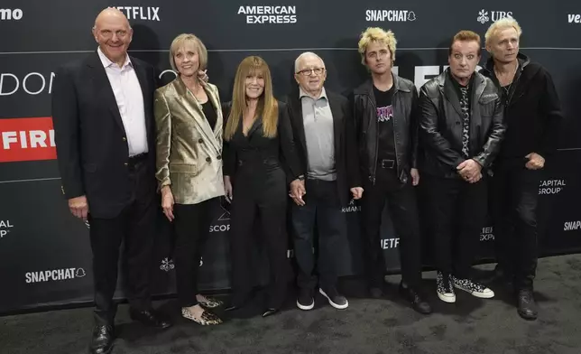 Steve Ballmer, from left, Connie Snyder, Shelli Azoff, and Irving Azoff, pose with Billie Joe Armstrong, Tre Cool, and Mike Dirnt of Green Day upon arrival at the FireAid benefit concert on Thursday, Jan. 30, 2025, at Intuit Dome in Inglewood, Calif. (Photo by Jordan Strauss/Invision/AP)