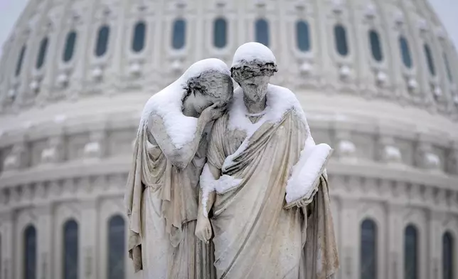 The Peace Monument, also known as the Naval Monument or Civil War Sailors Monument, is covered by snow outside the Capitol, Wednesday, Feb. 12, 2025, after a snowstorm in Washington. (AP Photo/Jacquelyn Martin)