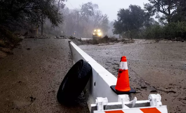A road is covered in mud in the Eaton Fire zone during a storm Thursday, Feb. 13, 2025, in Altadena, Calif. (AP Photo/Etienne Laurent)