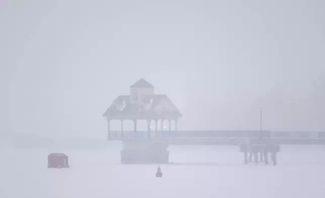 An ice shanty is set up on Saginaw River as a snowstorm rolls in on Wednesday, Feb. 12, 2025, in Bay City, Mich. (Kaytie Boomer/MLive.com/The Bay City Times via AP)