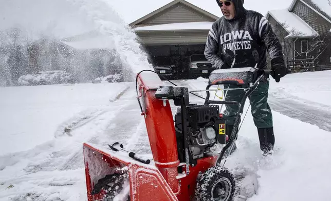 Rick Boland uses a snowblower to clear snow from his driveway in North Liberty, Iowa, Wednesday, Feb. 12, 2025. (Nick Rohlman/The Gazette via AP)