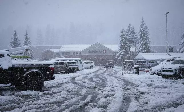 The parking lot to a Safeway supermarket is covered in snow during a storm Thursday, Feb. 13, 2025, in Truckee, Calif. (AP Photo/Brooke Hess-Homeier)