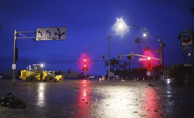 Mud covers Sunset Blvd. in the Palisades Fire zone during a storm Thursday, Feb. 13, 2025, in the Pacific Palisades neighborhood of Los Angeles. (AP Photo/Ethan Swope)