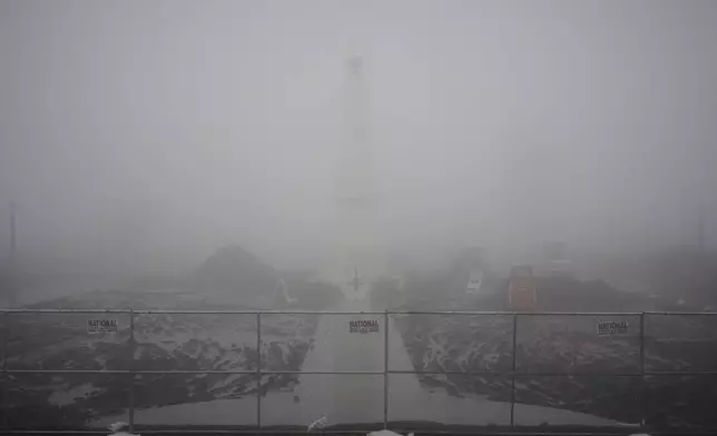 Fog covers the landscape during a rainstorm at the Griffith Park Observatory Thursday, Feb. 13, 2025, in Los Angeles. (AP Photo/Damian Dovarganes)