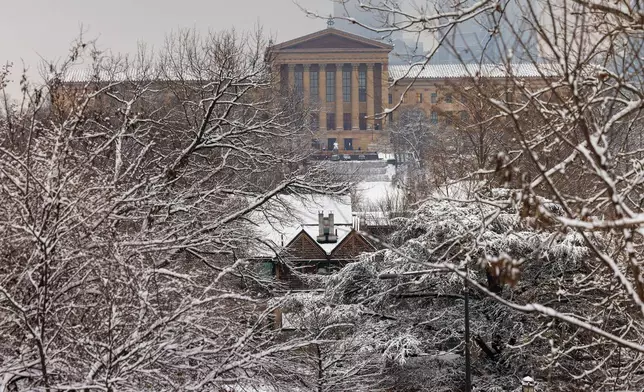 Snow covers the trees after an overnight show fall as the Philadelphia Museum of Art appears in the background in Philadelphia, Wednesday, Feb. 12, 2025. (Alejandro A. Alvarez/The Philadelphia Inquirer via AP)