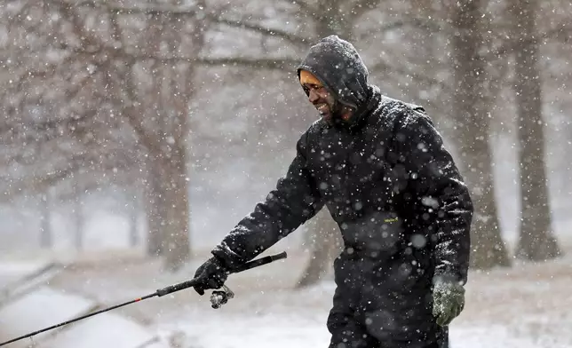 "Sometimes this is the best time to fish," said Ray King as he fishes for trout during a steady snowfall at the lake in O'Fallon Park in St. Louis, Mo., Wednesday, Feb. 12, 2025. (Robert Cohen/St. Louis Post-Dispatch via AP)