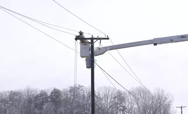Utility crews work on power lines after a winter storm blanketed the area Thursday, Feb. 13, 2025, Franklin County, Va. (Heather Rousseau