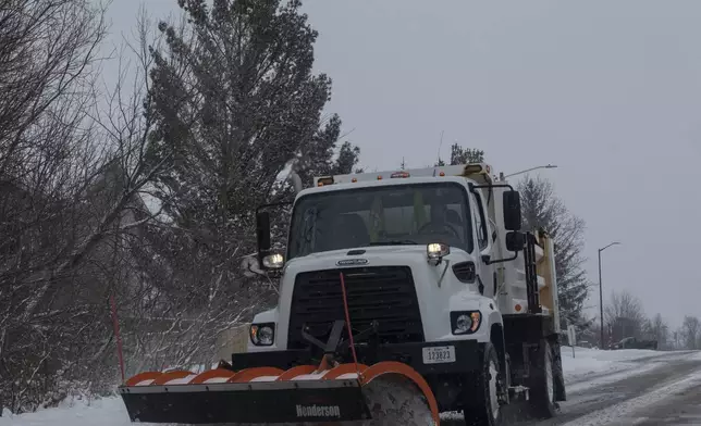 A snowplow clears a roadway in Coralville, Iowa on Wednesday, Feb. 12, 2025. (Nick Rohlman/The Gazette)
