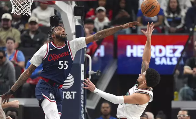 Memphis Grizzlies guard Scotty Pippen Jr., right, shoots as Los Angeles Clippers forward Derrick Jones Jr. defends during the first half of an NBA basketball game Wednesday, Feb. 12, 2025, in Inglewood, Calif. (AP Photo/Mark J. Terrill)